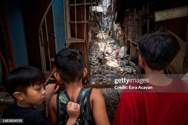 Children view a creek clogged with plastic waste on April 15, 2023 in Caloocan, Metro Manila, Philippines. The Philippines is the largest ocean...