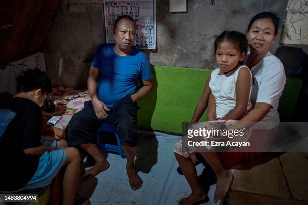 Corazon Mercado sits at home with her husband Leo Dakote and children Jose Gabriel and Bea on April 15, 2023 in Quezon city, Metro Manila,...