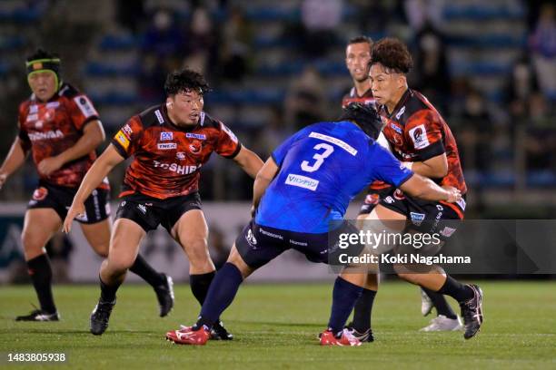 Yoshitaka Tokunaga of Toshiba Brave Lupus is tackled by Shohei Hirano of Saitama Panasonic Wild Knights during the Japan Rugby League One match...