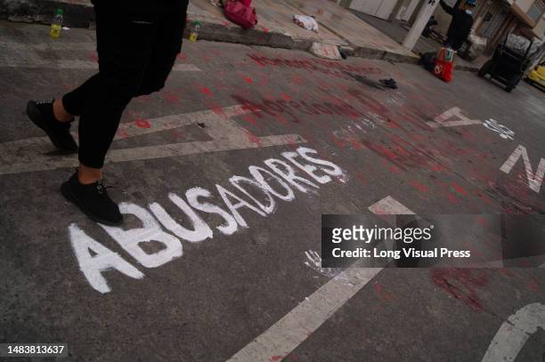 Demonstrator walks over the word 'Abusers' during a demonstration in which family members and students protest against alleged cases of homophobia...