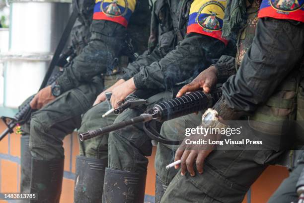 Guerrilla members hold firearms during the announcement by the FARC's Central General Staff to open peace talks with the Colombian government during...