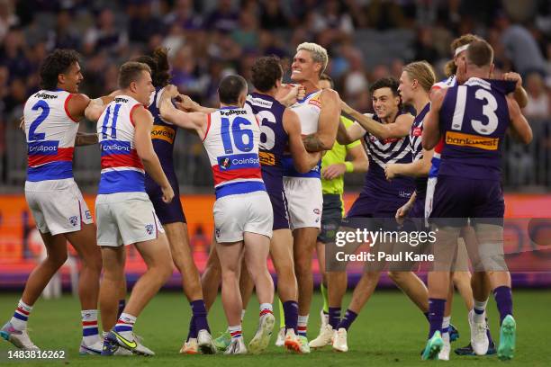 Rory Lobb of the Bulldogs wrestles with Alex Pearce and Brennan Cox of the Dockers before the first bounce during the round six AFL match between...
