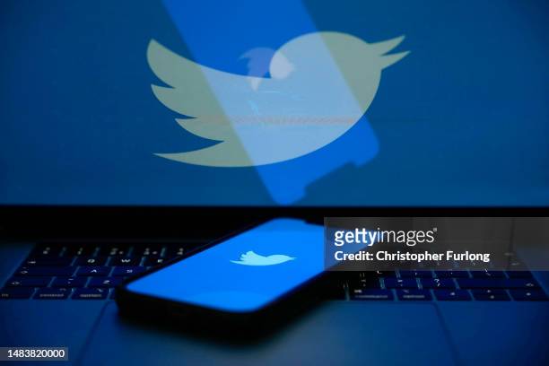 In this photo illustration the Twitter logo is seen on a computer screen and mobile cellphone on April 21, 2023 in Knutsford, United Kingdom. The...