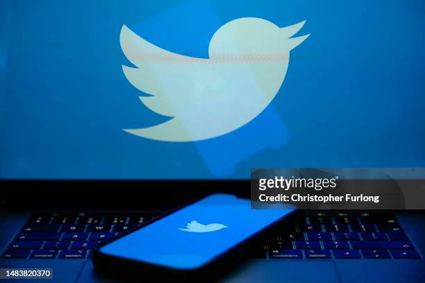 In this photo illustration the Twitter logo is seen on a computer screen and mobile cellphone on April 21, 2023 in Knutsford, United Kingdom. The...