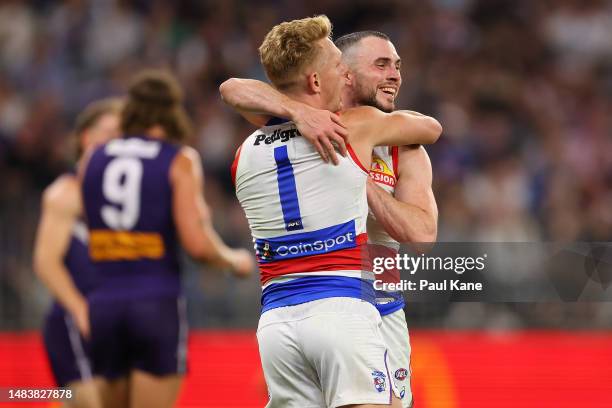 Adam Treloar and Toby McLean of the Bulldogs celebrate a goal during the round six AFL match between Fremantle Dockers and Western Bulldogs at Optus...