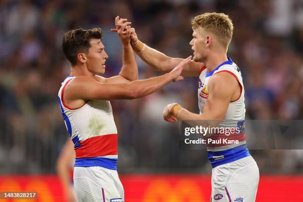 Anthony Scott and Adam Treloar of the Bulldogs celebrate a goal during the round six AFL match between Fremantle Dockers and Western Bulldogs at...