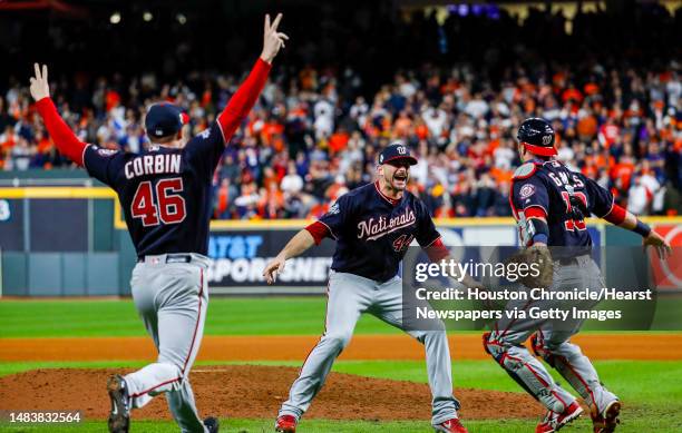 Washington Nationals pitcher Patrick Corbin and Washington Nationals catcher Yan Gomes run towards Washington Nationals relief pitcher Daniel Hudson...