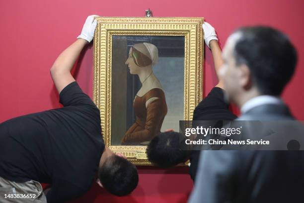 Staff members place Sandro Botticelli's masterwork 'Portrait of Simonetta Vespucci' in preparation for a grand exhibition of Botticelli and other...