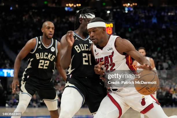 Jimmy Butler of the Miami Heat dribbles the ball against Jrue Holiday of the Milwaukee Bucks during the second half of Game Two of the Eastern...