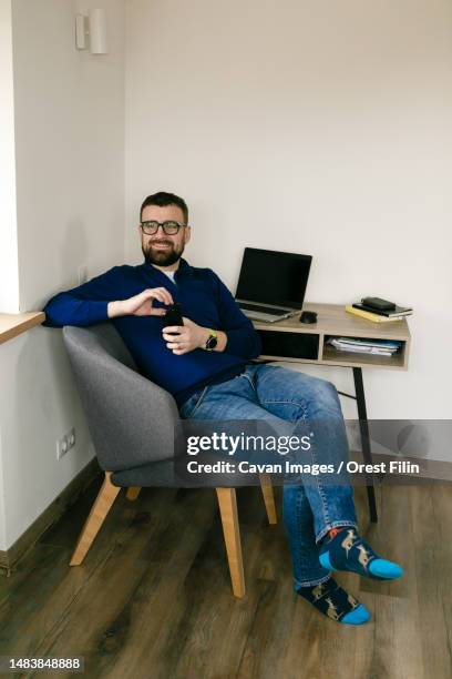 man sits at a desk with a laptop and books and thinks about business - sales execution stock pictures, royalty-free photos & images