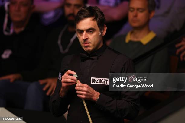 Ronnie O'Sullivan of England chalks the cue during their round two match against Hossein Vafaei of Iran on Day Seven of the Cazoo World Snooker...