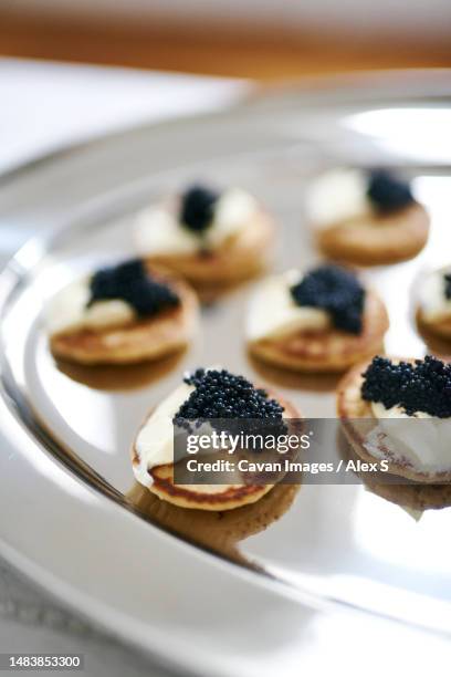 delicious looking caviar and cream cheese platter on silver tray - amuse bouche stockfoto's en -beelden