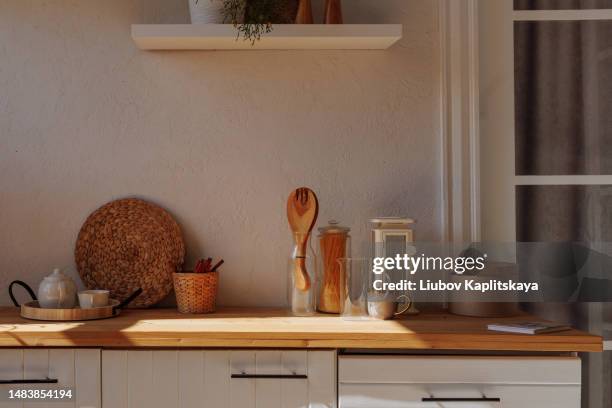 white kitchen interior with wooden countertop - privatküche stock-fotos und bilder