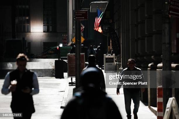 People walk by the New York Stock Exchange on April 21, 2023 in New York City. The Dow opened slightly up in morning trading after three consecutive...