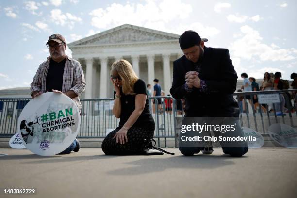 Rev. Pat Mahoney, Peggy Nienaber of Faith and Liberty and Mark Lee Dickson of Right to Life East Texas pray in front of the U.S. Supreme Court on...