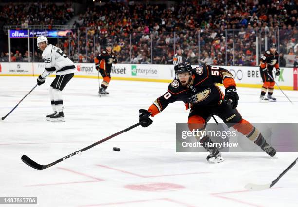 Benoit-Olivier Groulx of the Anaheim Ducks attempts to stop a pass to Quinton Byfield of the Los Angeles Kings during a 5-3 Kings win at Honda Center...