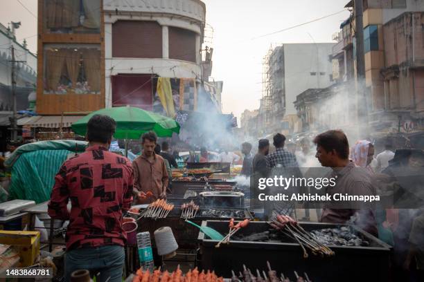 Muslim man prepares seekh kebabs on skewers on a street ahead of Eid al-Fitr on April 21, 2023 in Bengaluru, India. Eid Al-Fitr is the "festival of...