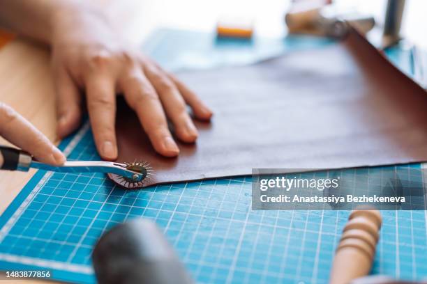 man making marks on leather for sewing - leather worker stock pictures, royalty-free photos & images