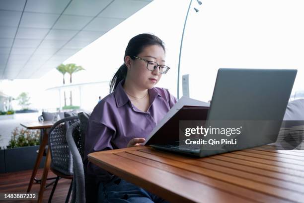 an asian lady orders food outside a cha-cha restaurant - directory stock pictures, royalty-free photos & images