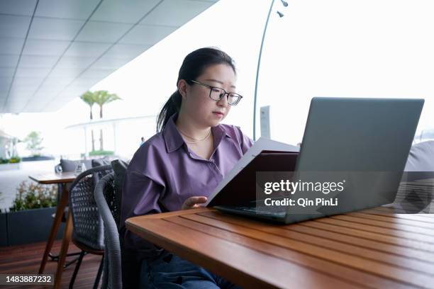 an asian lady orders food outside a cha-cha restaurant - telefonkatalog bildbanksfoton och bilder