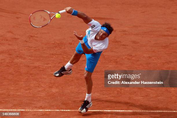 Juan Monaco of Argentinia serves during his finale match against Janko Tipsarevic of Serbia during day 6 of Mercedes Cup 2012 at the TC Weissenhof on...