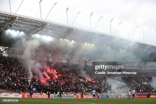 Action is briefly interrupted after a flare was thrown onto the field of play during the UEFA Youth League 2022/23 Semi-Final match between HNK...