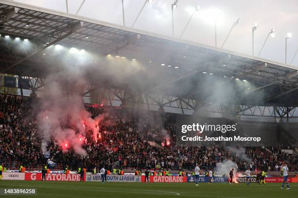 Action is briefly interrupted after a flare was thrown onto the field of play during the UEFA Youth League 2022/23 Semi-Final match between HNK...