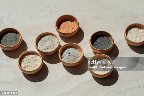 wooden bowls with different colours of clay powder. mask for rejuvenation and detoxification, pore cleansing of the face. - fango stock-fotos und bilder