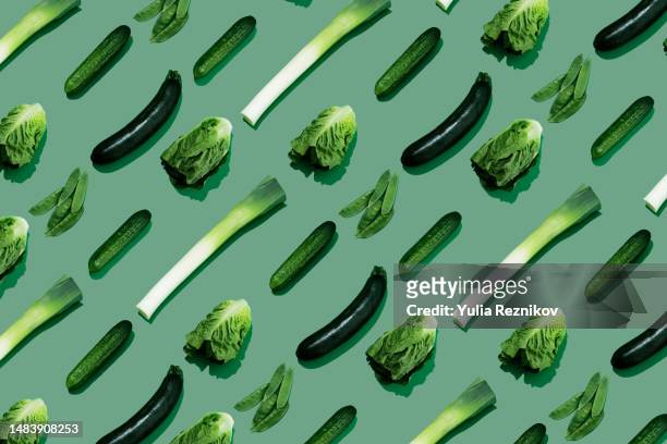 green vegetables (cucumber, napa cabbage, zucchini, leek) on the green background - cabbage stock pictures, royalty-free photos & images