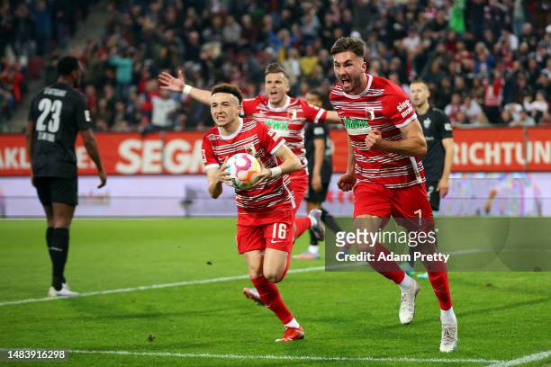 Dion Drena Beljo of Augsburg celebrates scoring the opening goal during the Bundesliga match between FC Augsburg and VfB Stuttgart at WWK-Arena on...
