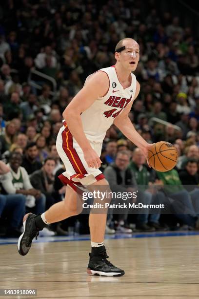 Cody Zeller of the Miami Heat dribbles the ball against the Milwaukee Bucks during the second half of Game Two of the Eastern Conference First Round...