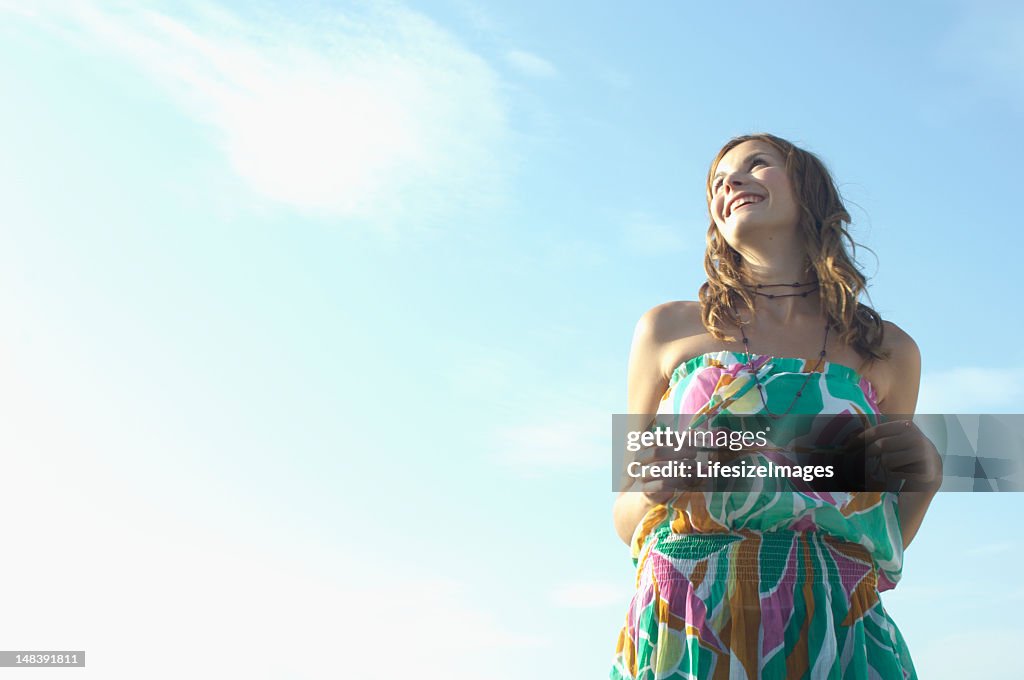 Teenage girl (16-18) outdoors, laughing, low angle view