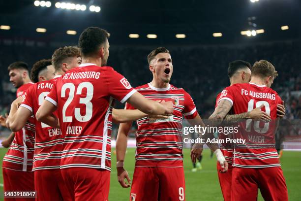 Augsburg celebrate their opening goal during the Bundesliga match between FC Augsburg and VfB Stuttgart at WWK-Arena on April 21, 2023 in Augsburg,...