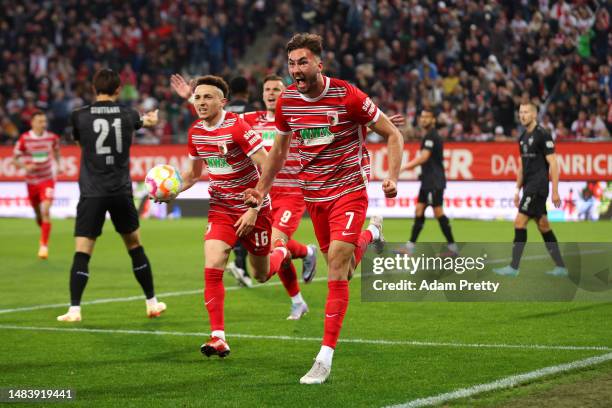 Dion Drena Beljo of Augsburg celebrates scoring the opening goal during the Bundesliga match between FC Augsburg and VfB Stuttgart at WWK-Arena on...