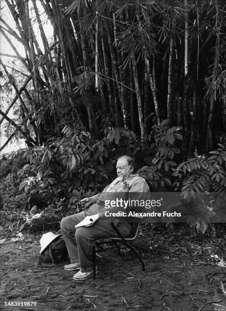 Actor Burl Ives reading by the set of the movie "The Spiral Road", in 1961 at Paramaribo, Suriname