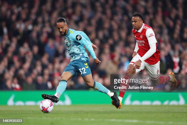 Theo Walcott of Southampton scores the team's second goal past Gabriel of Arsenal during the Premier League match between Arsenal FC and Southampton...