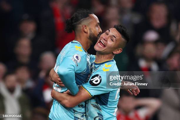 Theo Walcott of Southampton celebrates with teammate Carlos Alcaraz after scoring the team's second goal during the Premier League match between...