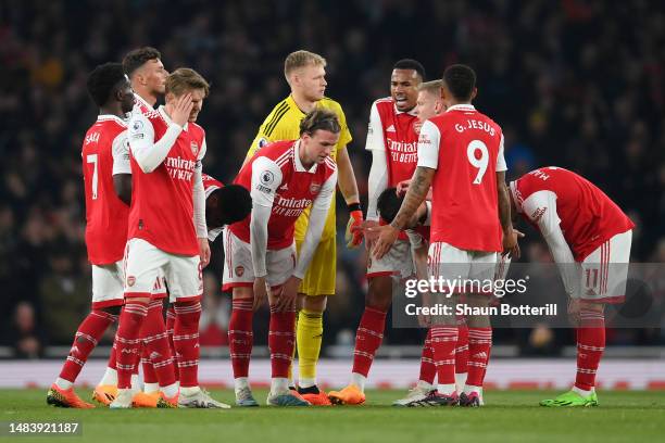 Rob Holding of Arsenal and teammates look dejected after conceding their side's second goal scored by Theo Walcott of Southampton during the Premier...