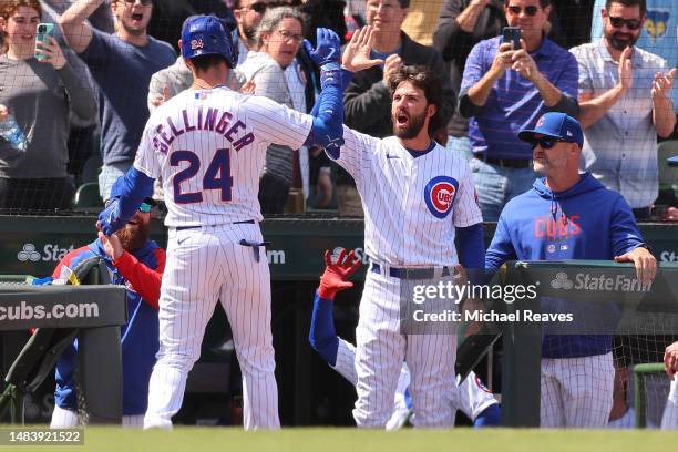 Cody Bellinger of the Chicago Cubs celebrates with Dansby Swanson after hitting a solo home run during the third inning against the Los Angeles...