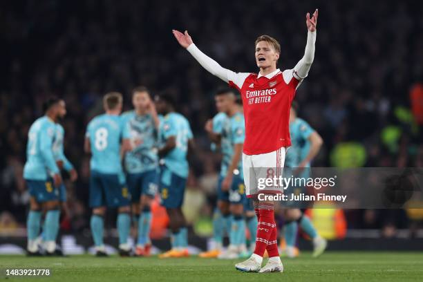 Martin Odegaard of Arsenal celebrates after teammate Gabriel Martinelli scored their side's first goal during the Premier League match between...