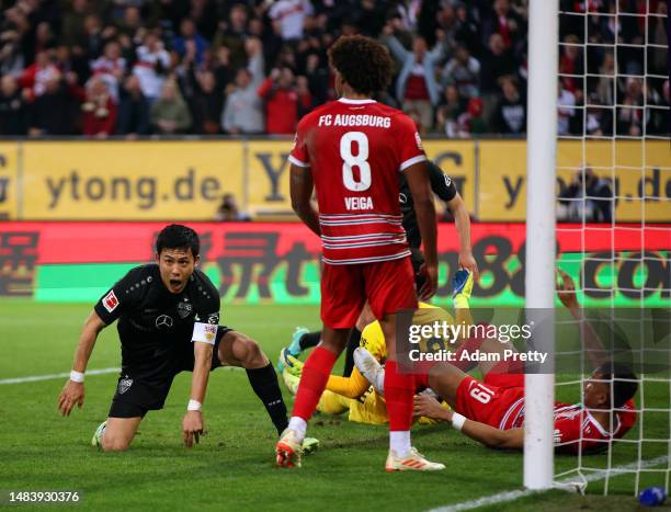 Wataru Endo of VfB Stuttgart reacts to scoring during the Bundesliga match between FC Augsburg and VfB Stuttgart at WWK-Arena on April 21, 2023 in...