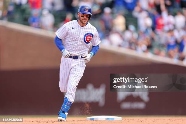 Patrick Wisdom of the Chicago Cubs rounds the bases after hitting a three-run home run off Jake Reed of the Los Angeles Dodgers during the fifth...