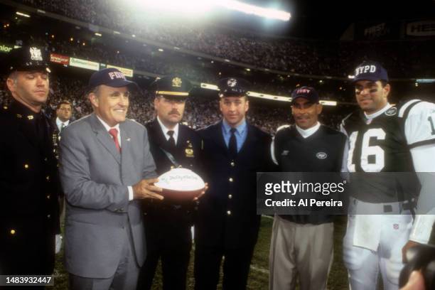 Head Coach Herman Edwards of the New York Jets wears an FDNY cap when he presents a game ball dedicated to The City of New York to Mayor Rudolph...