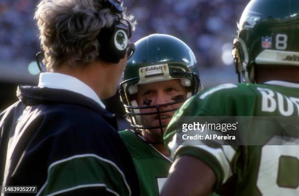 Quarterback Boomer Esiason of the New York Jets speaks with his position coach on the sideline in the game between the Philadelphia Eagles vs New...
