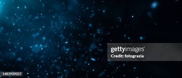 dust defocused particles against dark background - nevicata foto e immagini stock