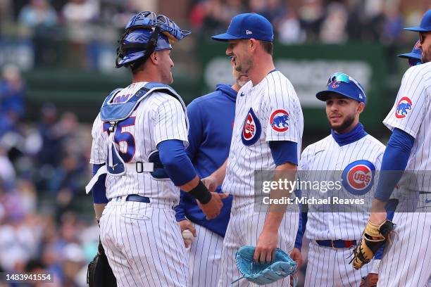 Drew Smyly of the Chicago Cubs laughs with Yan Gomes as he is taken out of the game during the eighth inning against the Los Angeles Dodgers at...