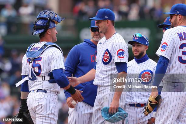 Drew Smyly of the Chicago Cubs laughs with Yan Gomes as he is taken out of the game during the eighth inning against the Los Angeles Dodgers at...