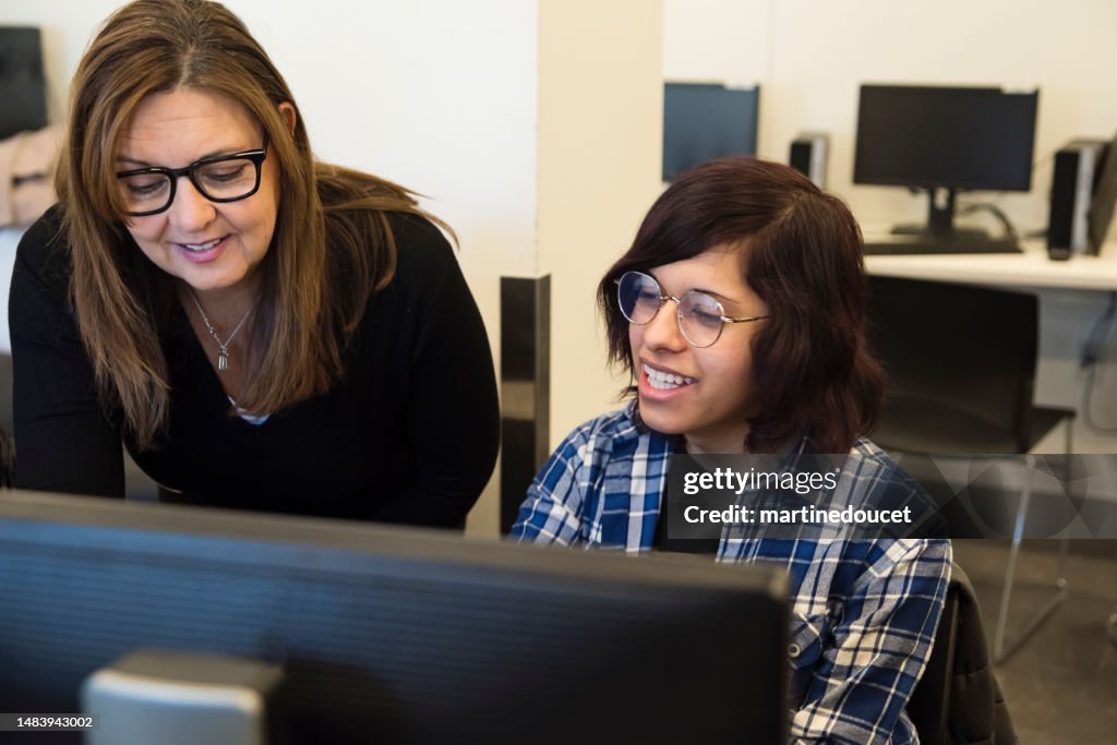 Student Coding Picture College Student Coding With Teacher In Tech Lab Classroom High-Res ...