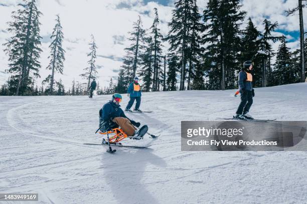 adaptive athlete learning to sit-ski - disabled extreme sports stock pictures, royalty-free photos & images