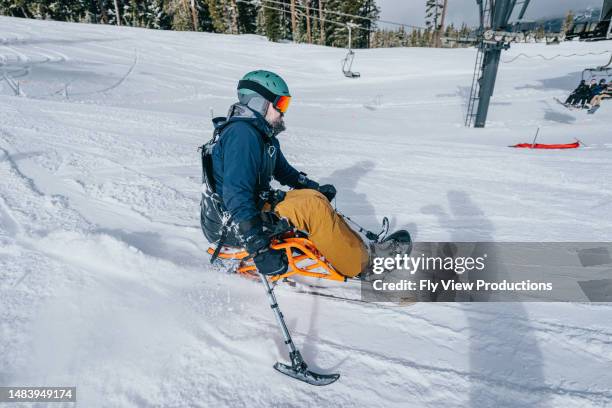 adaptive athlete sit-skiing on beautiful winter day - disabled extreme sports stock pictures, royalty-free photos & images